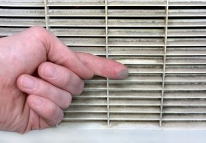 hand-wiping-dust-from-HVAC-vent